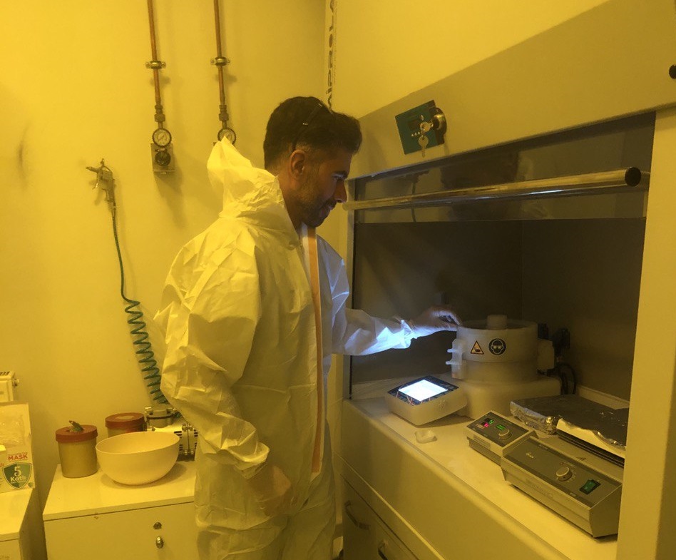 Iman Roknidoust, Ph.D. candidate in Physics at Eskişehir Osmangazi University, working under the supervision of Prof. Dr. Suat Pat, operating thin-film deposition equipment in a cleanroom environment.