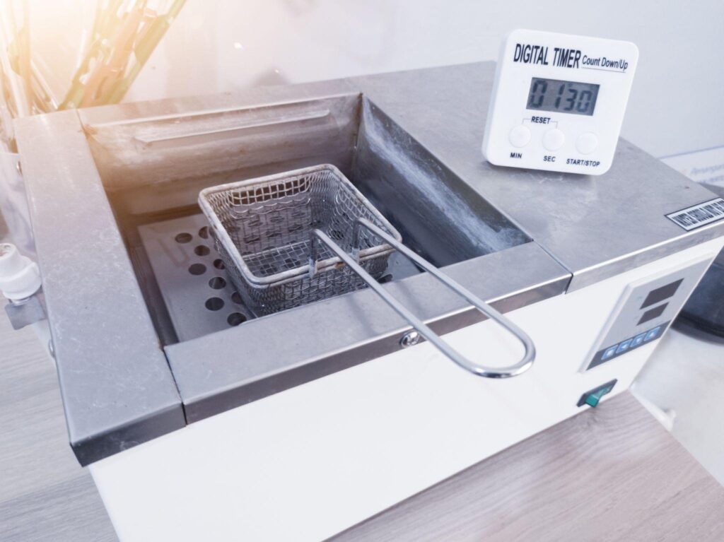 cleaning a laboratory water bath step by step with basket removed