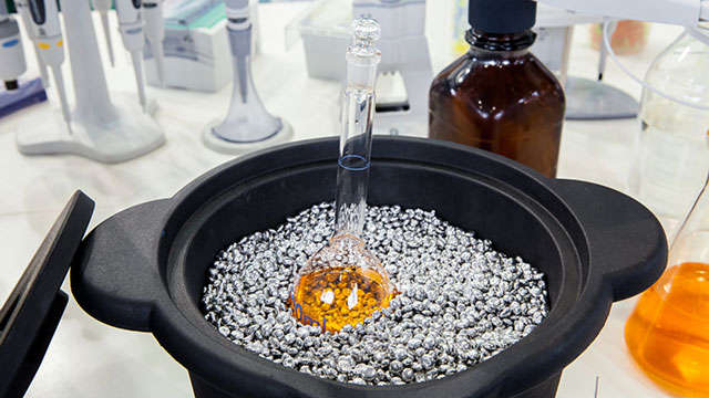 laboratory water bath used for indirect heating of chemical solution in glass flask